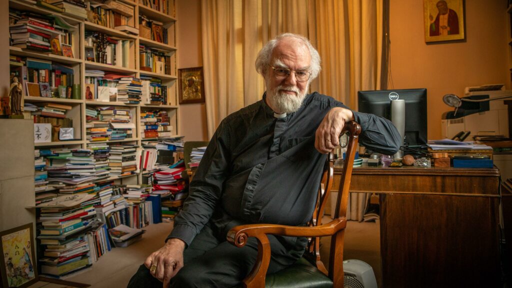Rowan Williams in his office surrounded by books. 